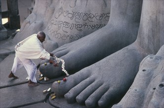 INDIA, Karnataka, Sravanabelagola, "Jain puja at feet of seventeen metre high naked statue of