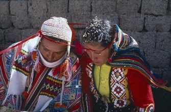 PERU, Cordillera, Vilcanota, Bride and groom during wedding ceremony encircled together with length