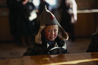 MONGOLIA, People, Children, Child in shop wearing hat with long ear flaps