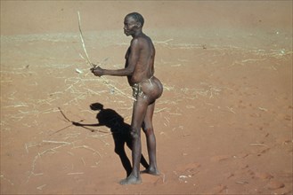 NAMIBIA, Kalahari Desert, Bushman hunting with bow and arrow.