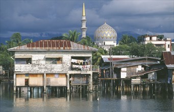 MALAYSIA, Borneo, Sabah, Kota Kinabalu  with stilt housing in the foreground