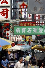 HONG KONG, General, Street scene displaying a mass of advertising signs and banners