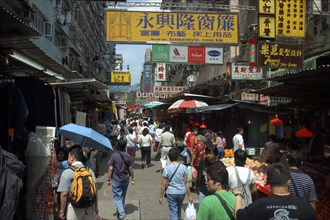 HONG KONG, General, Streetscene with shoppers and advertising banners overhead