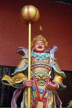 MALAYSIA, Kuala Lumpur, Chinatown, Colourful statue of a figure holding a staff