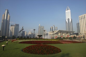 CHINA, Shanghai, Modern city skyline seen from gardens with formal flowerbeds in the foreground