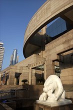 CHINA, Shanghai, Modern exterior of the Art Museum with white statue in surrounding pool
