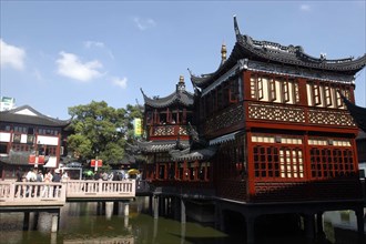 CHINA, Shanghai, Yuyuan Gardens. Bridge leading to traditional style architecture built on stilts