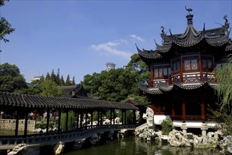 CHINA, Shanghai, Yuyuan Gardens. Covered bridge leading toward traditional style architecture built