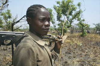 UGANDA, North, Portrait of a Karamojong tribesmen with an automatic weapon guarding cattle near
