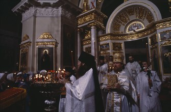 RUSSIA, Moscow`, St Daniil Monastery Orthodox priests in procession in front of the altar at Easter