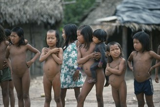 BRAZIL, Amazon, Xikrin children with strips of shaved hair and one small child with body painted