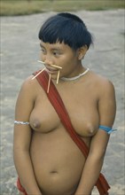BRAZIL, Roraima, Amazon, Portrait of Yanomami woman with facial piercings.