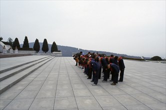 NORTH KOREA, Pyongyang, Group of children paying their respects at the Tomb of the Martyrs outside