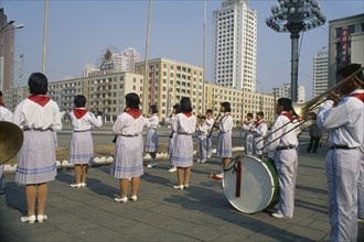 NORTH KOREA, Pyongyang, Juche ideology.  Band playing outside the railway station to encourage