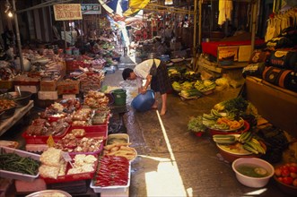 SOUTH KOREA, Kangwon, Sokcho, Women rinsing bowl at street market selling fruit and vegetables and