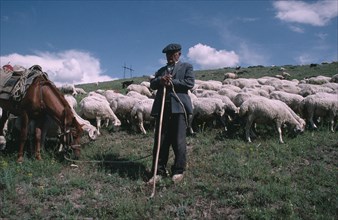 ARMENIA, Djermuk, Shepherd with horse and flock.
