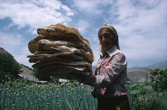 ARMENIA, Areni, "Woman holding pile of lavash, the local bread."