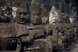 CAMBODIA, Siem Reap, Angkor Thom, South Gate causeway lined with statues of various gods the paler