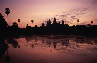 CAMBODIA, Siem Reap, Angkor Wat, The central complex seen across the water lilly pond at sunrise