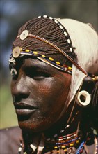 KENYA, Tribal People, Portrait of Samburu warrior wearing ochre body paint and ivory ear plug.