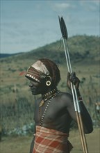KENYA, Tribal Poeple, Threequarter portrait of Masai Moran warrior holding spear