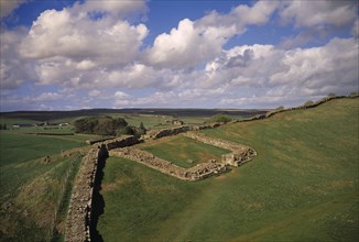 ENGLAND, Northumberland, Hadrians Wall, Cawfields Milecastle along section of ruined wall over Whin