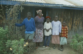 KENYA, Families, Portrait of rural family standing outside house near Bomet.