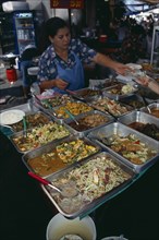 THAILAND, South, Bangkok, Woman selling cooked meals in an alley beside Patpong 1
