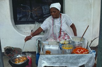 BRAZIL, Bahai, Woman cooking on street stall serving traditional slave food.