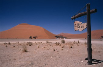 NAMIBIA, Namib Desert, Dune 45 sign with the sand dune behind which is a popular tourist climb