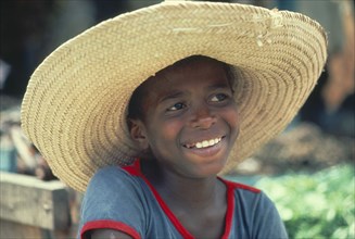 BRAZIL, Tribal People, Smiling boy wearing wide brimmed straw hat.