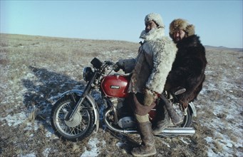 MONGOLIA, Transport, Mongol Ton up men on motorbike dressed in fur clothes.