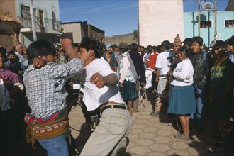 BOLIVIA, Potosi, Macha, Traditional Tinku fighting festival.  Crowds watching two young men
