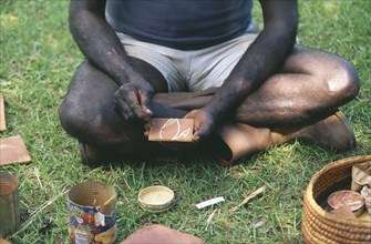 AUSTRALIA, Northern Territory, Manyallaluk, Aborigine demonstrating tradition bark painting