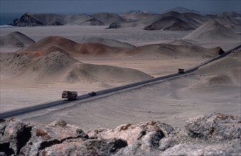 PERU, Landscape, Car and buses on the Pan American highway through coastal desert area