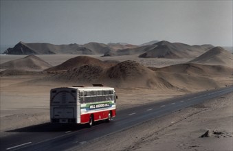 PERU, Landscape, Bus on the Pan American highway through coastal desert connecting Ecuador and