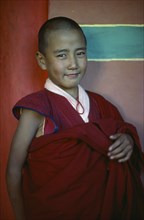 INDIA, West Bengal, Darjeeling, Portrait of a novice Buddhist monk.