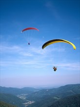FRANCE, Alsace, Haut Rhin, Paragliders decending from Ballon de l Alsace