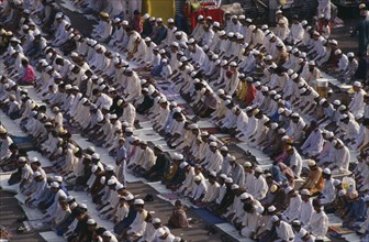 BANGLADESH, Dhaka, Rows of Muslims kneeling in prayer.