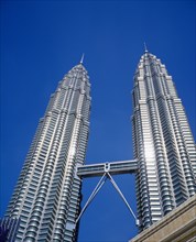 MALAYSIA, Kuala Lumpur, Petronas Twin Towers. Angled view looking up at the multi storey buildings