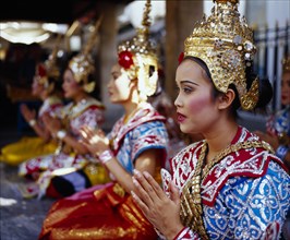 THAILAND, Bangkok, Erawan Shrine. Dancers performing for devotees who give thanks for good luck