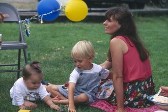 USA, Rhode Island, Westerly, Woman and two young children at barbecue.
