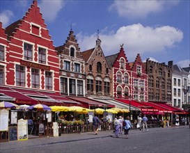 BELGIUM, West Flanders, Bruges, Line of cafes and restaurants with colourful awnings in Bruges