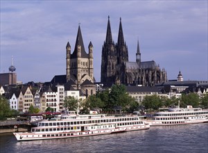 GERMANY, Rhine Westphalia, Cologne, View over tour boats on the River Rhine to Cologne Cathedral