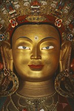 INDIA, Ladakh, General, Golden face of Buddha.  Tibetan Buddhism is practised in this area of