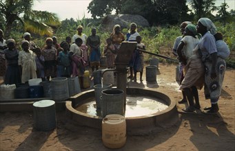 MOZAMBIQUE, Inhambane Province, Water, Village women and children using UNICEF water well.  Water