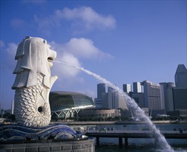 SINAGAPORE, General, Merlion statue spouting water in to the Singapore River with the city skyline