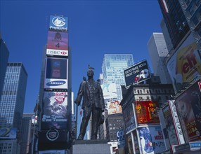 USA, New York, Manhattan, Times Square architecture and billboards with statue in the foreground