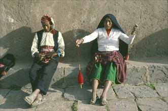 PERU, Puno, Lake Titicaca, Taquile.  Couple weaving.