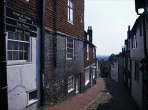 20059219 ENGLAND East Sussex Lewes View down cobbled old street with cottage housing and a street sign showing directions towards the Ann of Cleves House and The Priory.